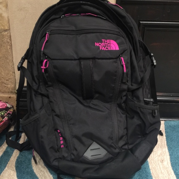 black and pink north face backpack