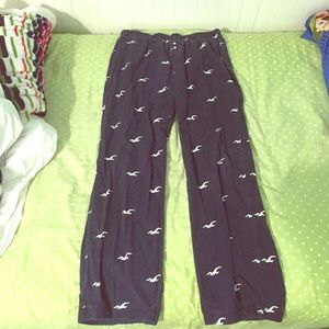 Navy blue pajama pants with white Hollister logos