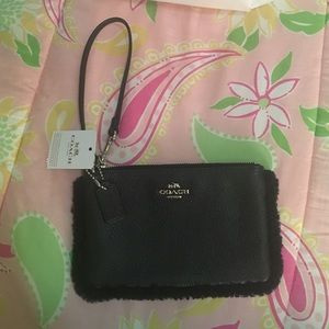 Black leather coach wristlet with faux fur trim