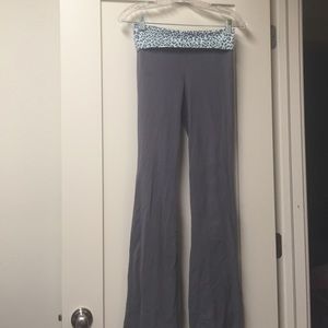 A pair of gray yoga pants with leopard print.