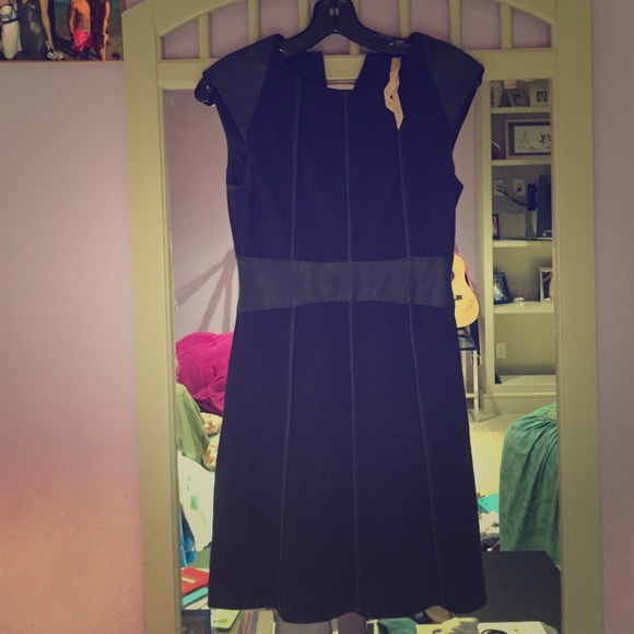Navy dress with leather sash and patterns