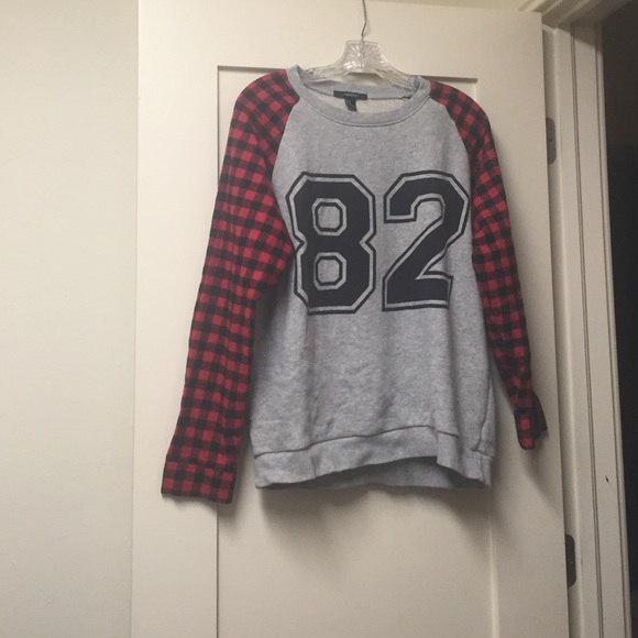 A plaid patterned sweater that says "82".