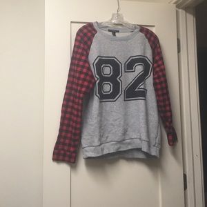 A plaid patterned sweater that says "82".