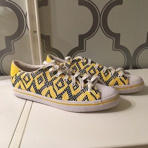 Tribal print adidas shell toe shoes.