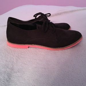 Pink soled, black suede shoes