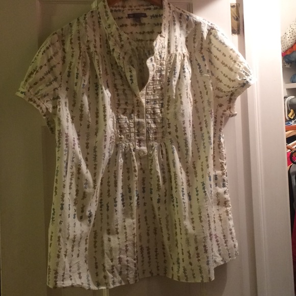 Cream flower print top with pleated yoke.