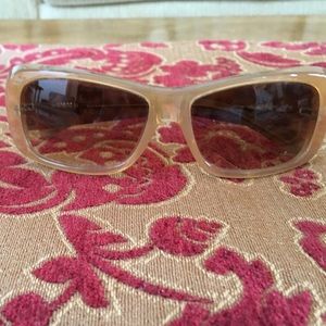 Miu Miu sunglasses with leopard print temples.