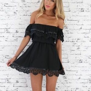 A black dress with lace and ribbon details.