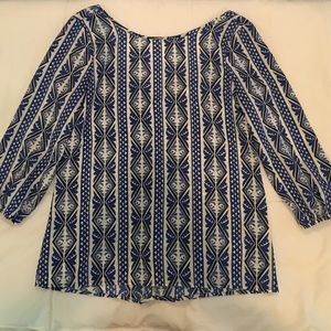 Blue and white open-back printed blouse