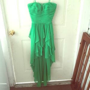 A romantic strapless green high low dress.