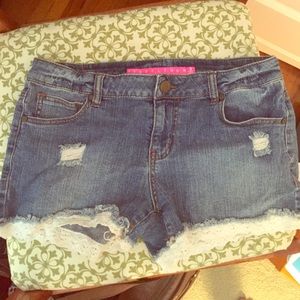 Adorable medium-wash jean shorts with lace details
