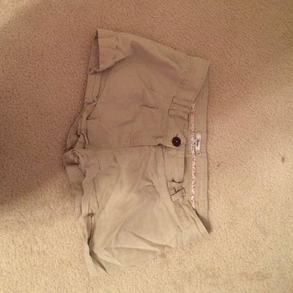 Tan colored shorts with belt loops and pockets