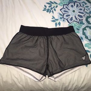 Black mesh running shorts by Varsity