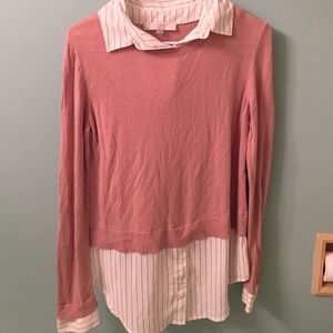Pink sweater with a white blouse underneath