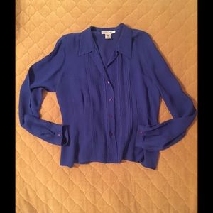 100% silk blue blouse. Like new size medium.