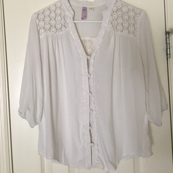 White blouse with floral accents