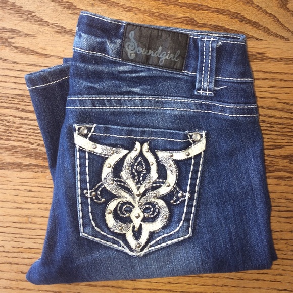 Dark wash boot-cut jeans with decorative pockets