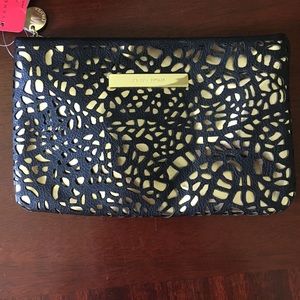 Ivanka Trump laser cut black and gold clutch