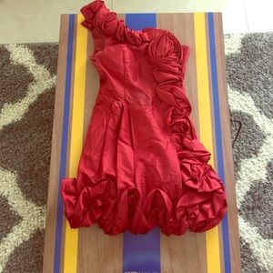 Red one shoulder/strap cocktail dress.