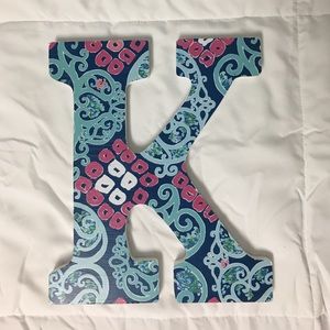 A wooden letter "K" with decal