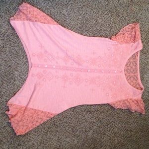 A light orange shirt  with a see through lace
