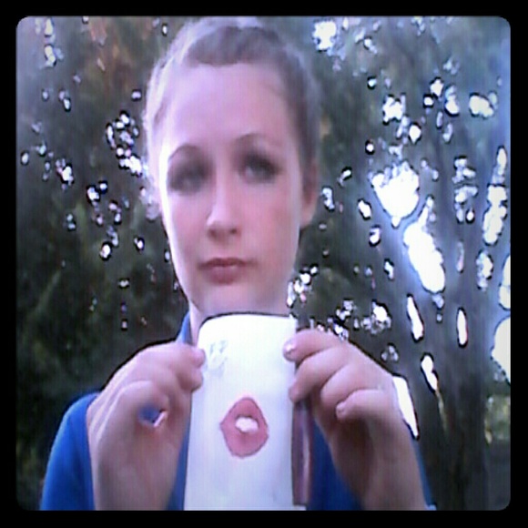 Liquid lipstick and a piece of paper kissed by her