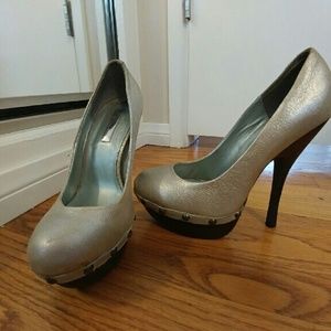 Light gold pumps with high brown heel.