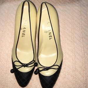 Beige and black Chanel heels with bow