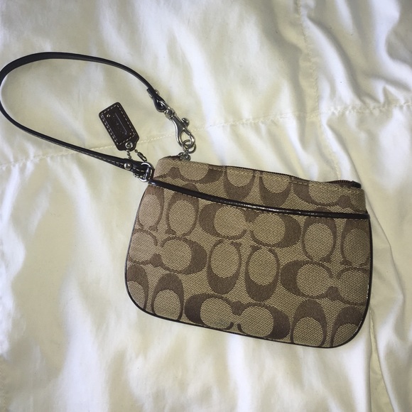 Brown classic Coach wristlet.