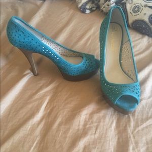 Blue swayed leather heel.