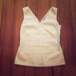 Flattering white V-neck sleeveless top.