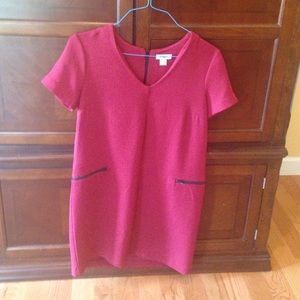 Red dress with black zippers.