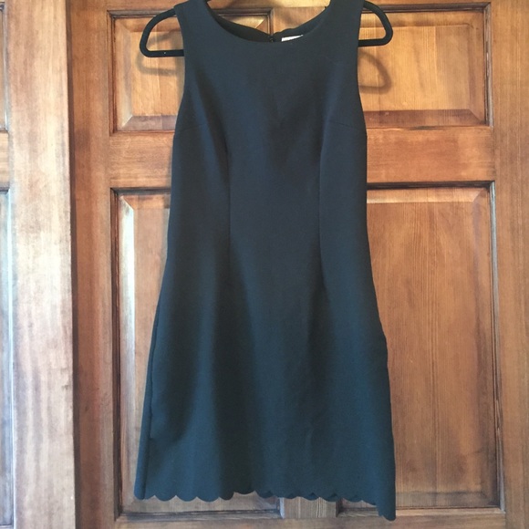 Form fitting black dress with scallops on bottom. - Picture 1 of 3