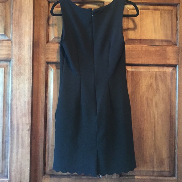 Form fitting black dress with scallops on bottom. - Picture 3 of 3