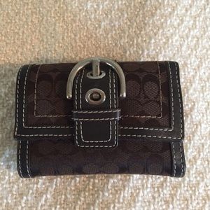 Small brown Coach wallet with buckle detail