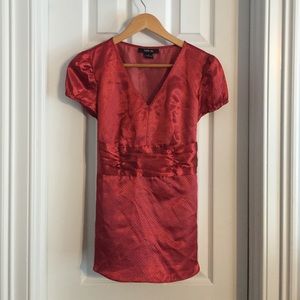 Red, patterned blouse.