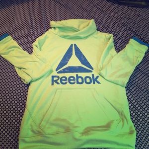 Reebok hood less light weight pullover runs small.