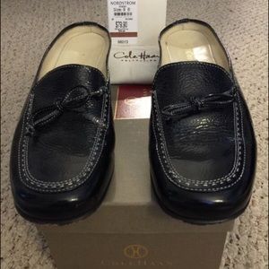 Cole Haan black slide loafers.