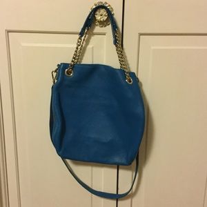 Blue Michael Kors purse.