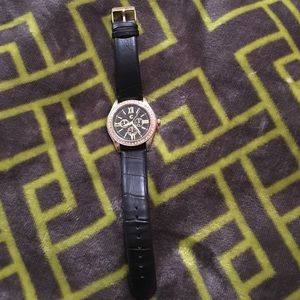 Francesca's black and gold watch