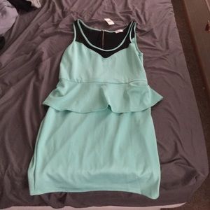 Peplum dress with mesh trim.