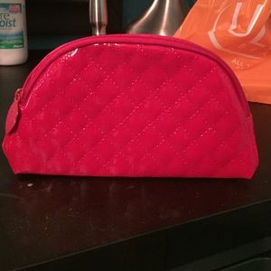 Hot pink make up bag with crossed stitching!