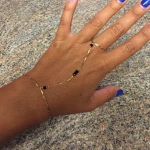 Gold finger bracelet w/ black stones