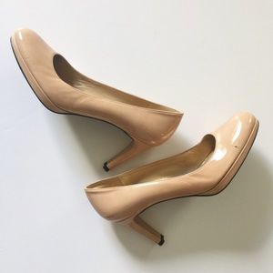 Nude patent leather heels.