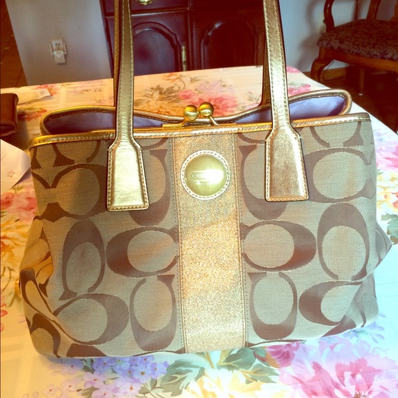 beige Coach handbag