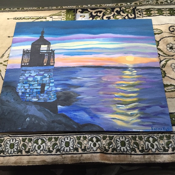 Painting of a sunset and light house in the ocean