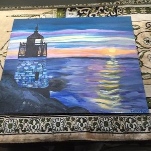 Painting of a sunset and light house in the ocean