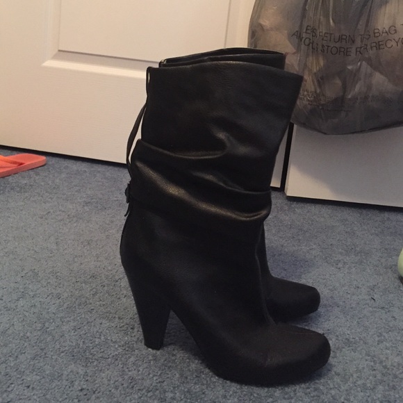 Black mid-calf boots with a buckle on the back
