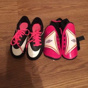 Nike soccer cleats and pink shin guards