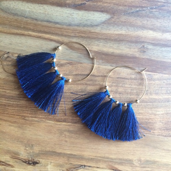 Blue tassel hoop earrings.